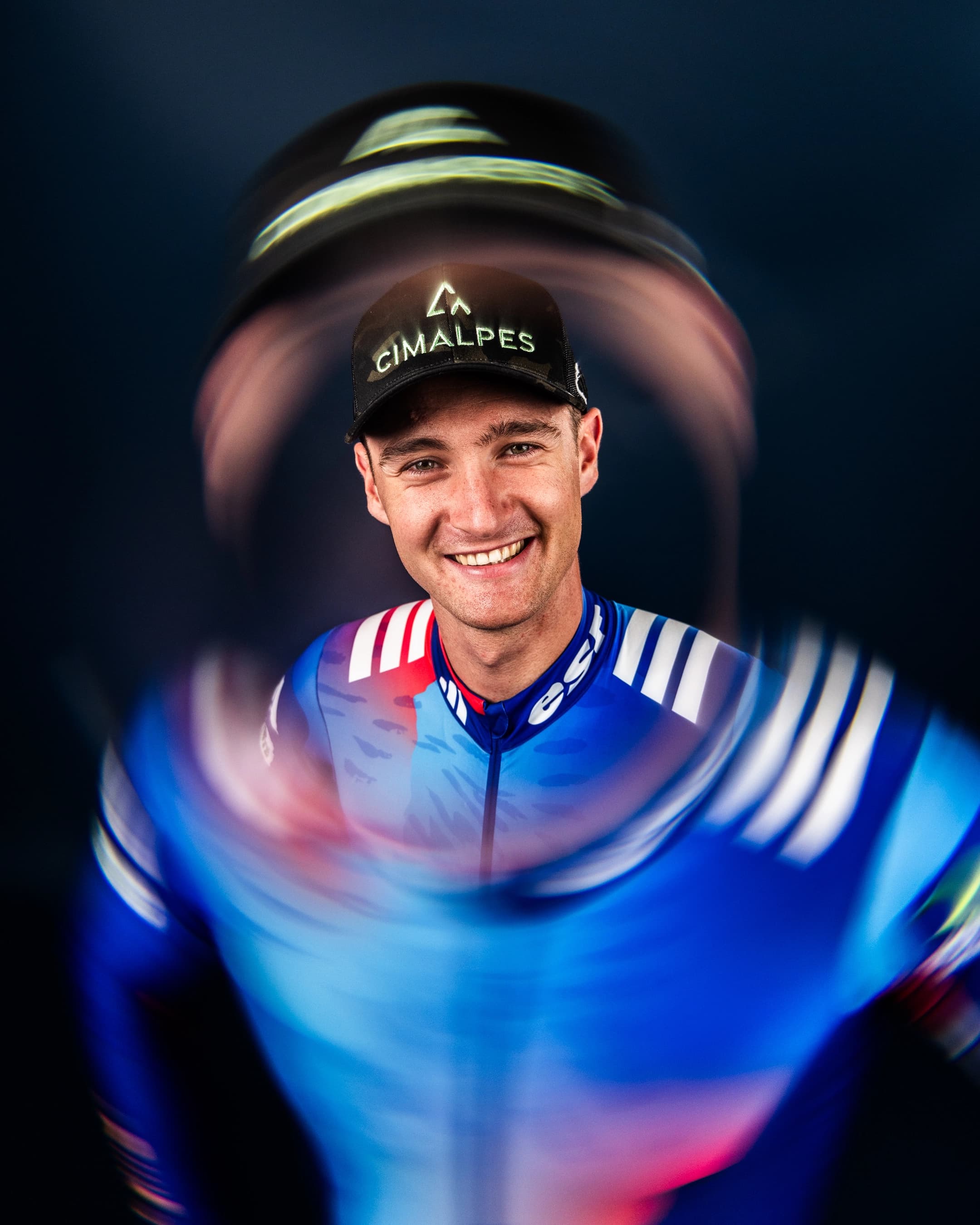 Mathis Desloges souriant au centre d'un effet de rotation en tenue de l'équipe de France